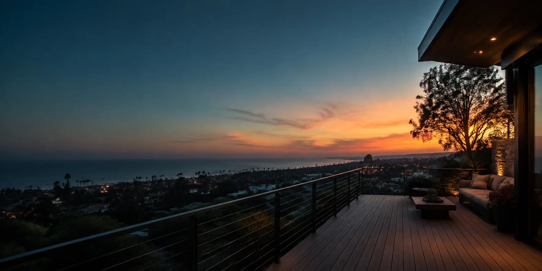 A residential deck overlooking a coastal neighborhood at sunset